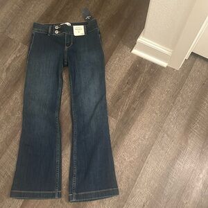 Wide leg, darker blue jeans and low rise